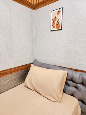 a bed with a pillow in a room at 109 Homely Apartment Free Wi-Fi Near BTS in Bangkok