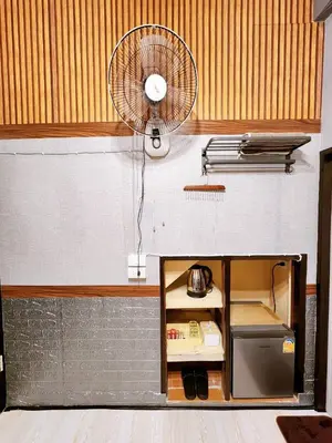 a kitchen with a fan on the wall at 109 Homely Apartment Free Wi-Fi Near BTS in Bangkok