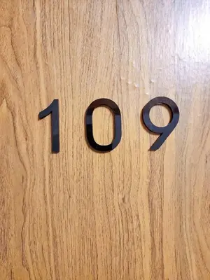 a wooden table with the number on it at 109 Homely Apartment Free Wi-Fi Near BTS in Bangkok