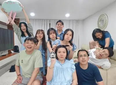 a group of people posing for a picture in a living room at Center at Bangrak in Bangkok