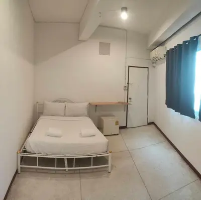 a small bedroom with a bed in a room at XX GO INN Asiatique Charoen krung V โกอินน์ เอเซียทีค เจริญกรุง in Bangkok
