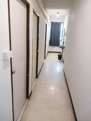 a corridor of an empty hallway with doors and a hallwayngth at XX GO INN Asiatique Charoen krung V โกอินน์ เอเซียทีค เจริญกรุง in Bangkok