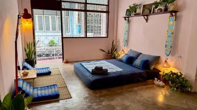 a bedroom with a large bed and a large window at Baan YentaFo - Pink House 2nd floor in Chinatown