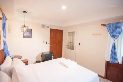 a bedroom with a white bed and a window at JB Home Bangkok - Victory monument in Bangkok