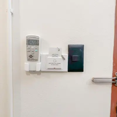 a door with a cell phone and a box on it at JB Home Bangkok - Victory monument in Bangkok