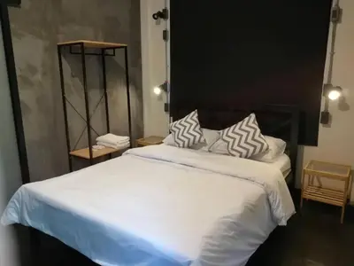 a bedroom with a large bed with white sheets and pillows at silom Dream catcher rainbow hostel in Bangkok