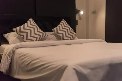 a white bed with pillows on top of it at silom Dream catcher rainbow hostel in Bangkok