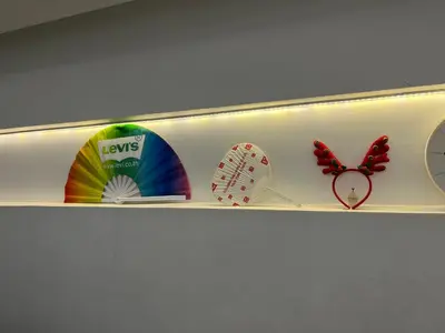 a shelf with a bunch of clocks and a butterfly at silom Dream catcher rainbow hostel in Bangkok