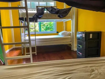 a bedroom with a bunk bed and a window at Green Garden Hostel in Bangkok