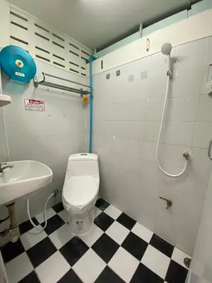 a bathroom with a toilet and a sink at Green Garden Hostel in Bangkok