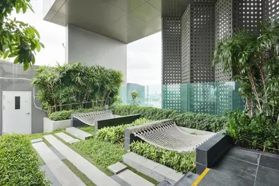 a building with two benches and trees and plants at 5mins walk to BTS Thonglor, easy access 1 bedroom in Bangkok