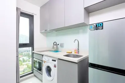 a white kitchen with a sink and a washing machine at 5mins walk to BTS Thonglor, easy access 1 bedroom in Bangkok