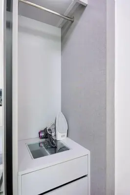 a white bathroom with a sink and a mirror at 5mins walk to BTS Thonglor, easy access 1 bedroom in Bangkok