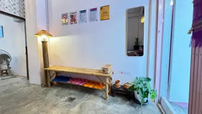 a room with a bench and a lamp on a wall at Baan YentaFo - Pink House 4th floor in Chinatown