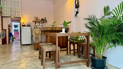 a kitchen with a table and some potted plants at Baan YentaFo - Pink House 4th floor in Chinatown
