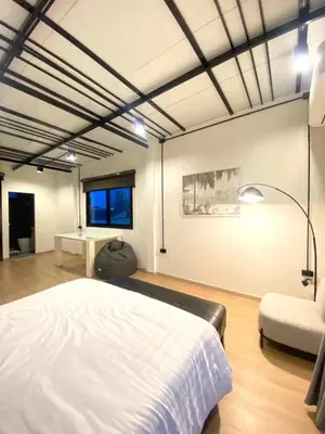 a bedroom with a white bed and a chair at 4Beds 4Baths New Renovated Entire House BTS Ekkamai in Bangkok