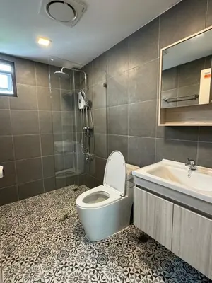 a bathroom with a toilet and a sink at 4Beds 4Baths New Renovated Entire House BTS Ekkamai in Bangkok