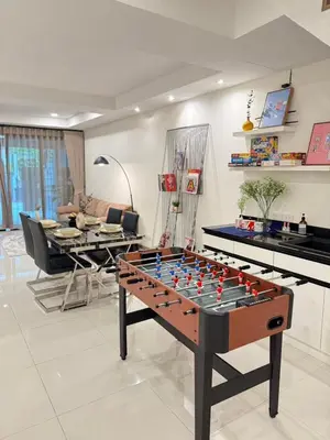 a living room with a foos ball on a table at 4Beds 4Baths New Renovated Entire House BTS Ekkamai in Bangkok