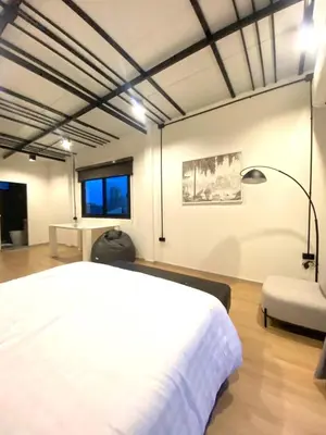 a bedroom with a white bed and a chair at 4Beds 4Baths New Renovated Entire House BTS Ekkamai in Bangkok