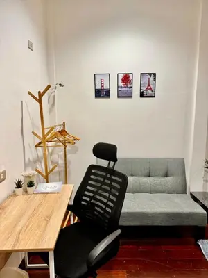 a living room with a couch and a table at Twenty One Place in Bangkok
