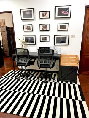 a room with a desk and chairs on a striped rug at Twenty One Place in Bangkok