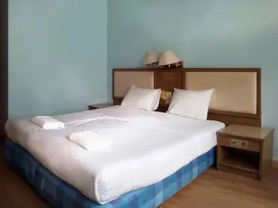 a bedroom with a large white bed with two pillows at XX Wish Inn Chidlom V วิช อินน์ ชิดลม 2 in Bangkok