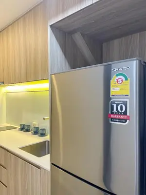 a refrigerator with a sign on it in a kitchen at 2BR BTS On Nut Siamese87 Two Bedroom LOFT hight floor 24 in Bangkok