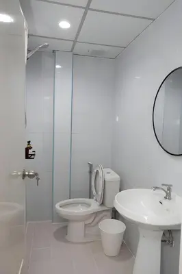 a bathroom with a toilet and a sink and a mirror at Elite Hotel Nana Sukhumvit 3 in Bangkok