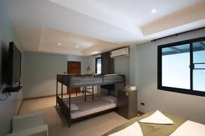 a room with two bunk beds and a window at Arttra Villa in Bang Chak