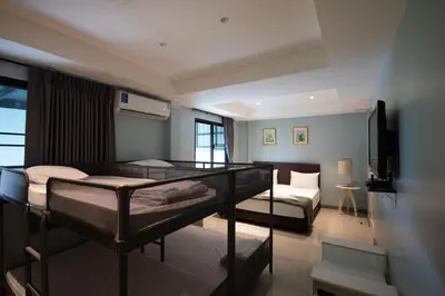 a bedroom with two bunk beds in a room at Arttra Villa in Bang Chak