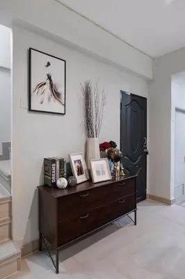 a living room with a dresser and a black door at 4BR house MRT subway 250m Chatujak Market wi-fi in Bangkok