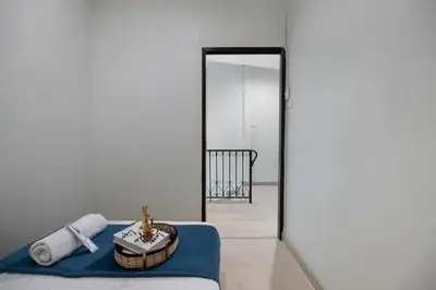 a mirror in a room with a bed and a basket at 4BR house MRT subway 250m Chatujak Market wi-fi in Bangkok