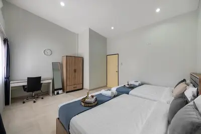 a bedroom with two beds and a desk and a computer at 4BR house MRT subway 250m Chatujak Market wi-fi in Bangkok
