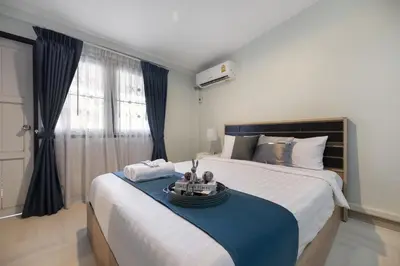 a bedroom with a bed with a blue table on it at 4BR house MRT subway 250m Chatujak Market wi-fi in Bangkok