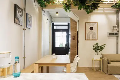 a living room with a table and a couch at Wabisabi Bangkok 3 MIN To Train Station in Bangkok