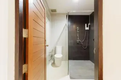 a bathroom with a toilet and a shower at Wabisabi Bangkok 3 MIN To Train Station in Bangkok