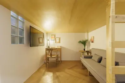 a living room with a couch and a table at Wabisabi Bangkok 3 MIN To Train Station in Bangkok