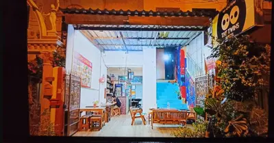 a view of a restaurant with tables and chairs at The Twins Hostel in Bangkok
