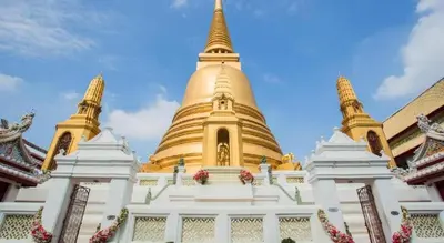 a large golden pagoda in a building at The Twins Hostel in Bangkok