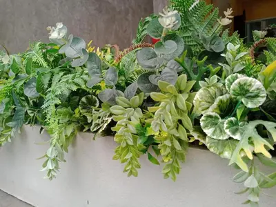 a large pot filled with green plants and flowers at Your Place Hotel in Bangkok