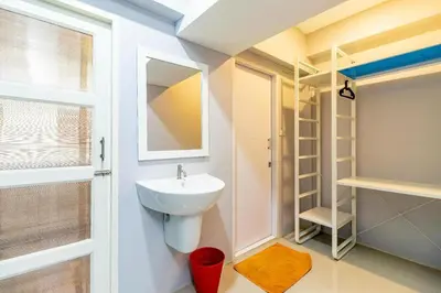 a bathroom with a sink and a mirror at Your Place Hotel in Bangkok