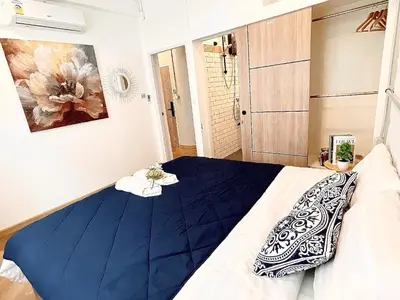 a bedroom with a bed with a blue blanket at Great relaxing in oldtown, Entire floor, near Grand Palace in Bangkok