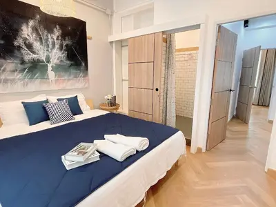 a bedroom with a large bed with blue sheets and pillows at Great relaxing in oldtown, Entire floor, near Grand Palace in Bangkok