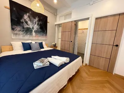 a bedroom with a large blue bed with towels on it at Great relaxing in oldtown, Entire floor, near Grand Palace in Bangkok