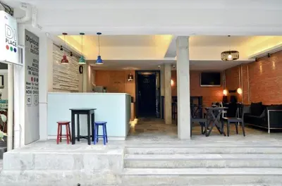 a lobby of a building with tables and chairs at DI Place in Bangkok