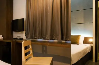 a bedroom with a desk with a bed and a desk sidx sidx sidx at DI Place in Bangkok