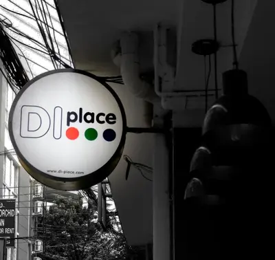a dol place sign hanging from the side of a building at DI Place in Bangkok