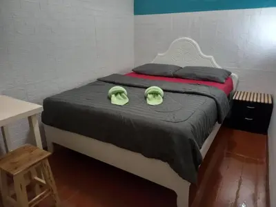 a bed with two green towels on top of it at Sleep at home hostel in Bangkok