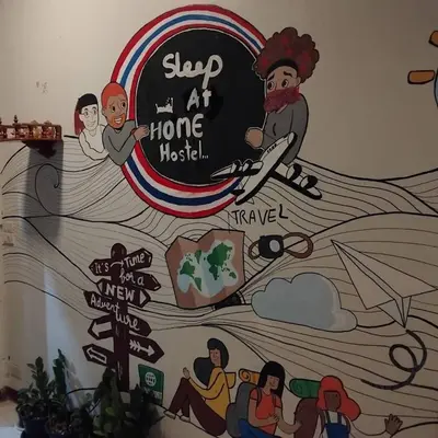 a mural on a wall in a room at Sleep at home hostel in Bangkok