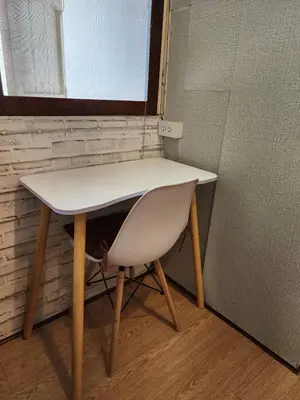 a white table and a chair in a room at 207-Olan Place Homely room Free Wi-Fi and Near BTS line in Bangkok